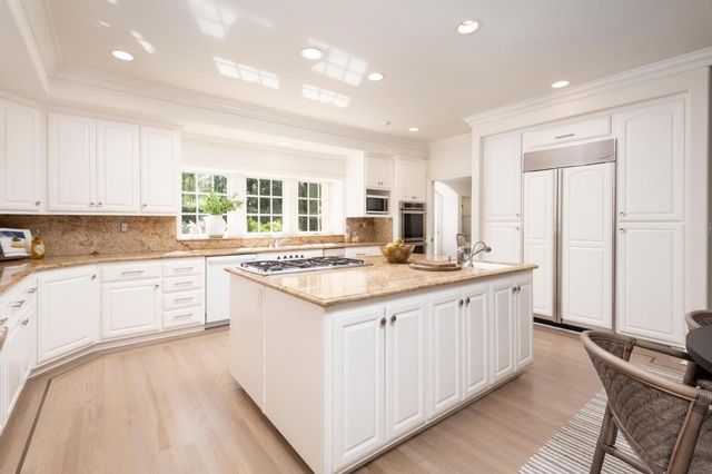 a living room with furniture a fireplace and a large window