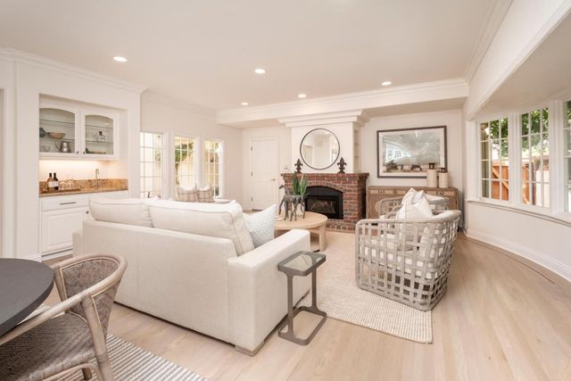 a living room with furniture a rug and a large window