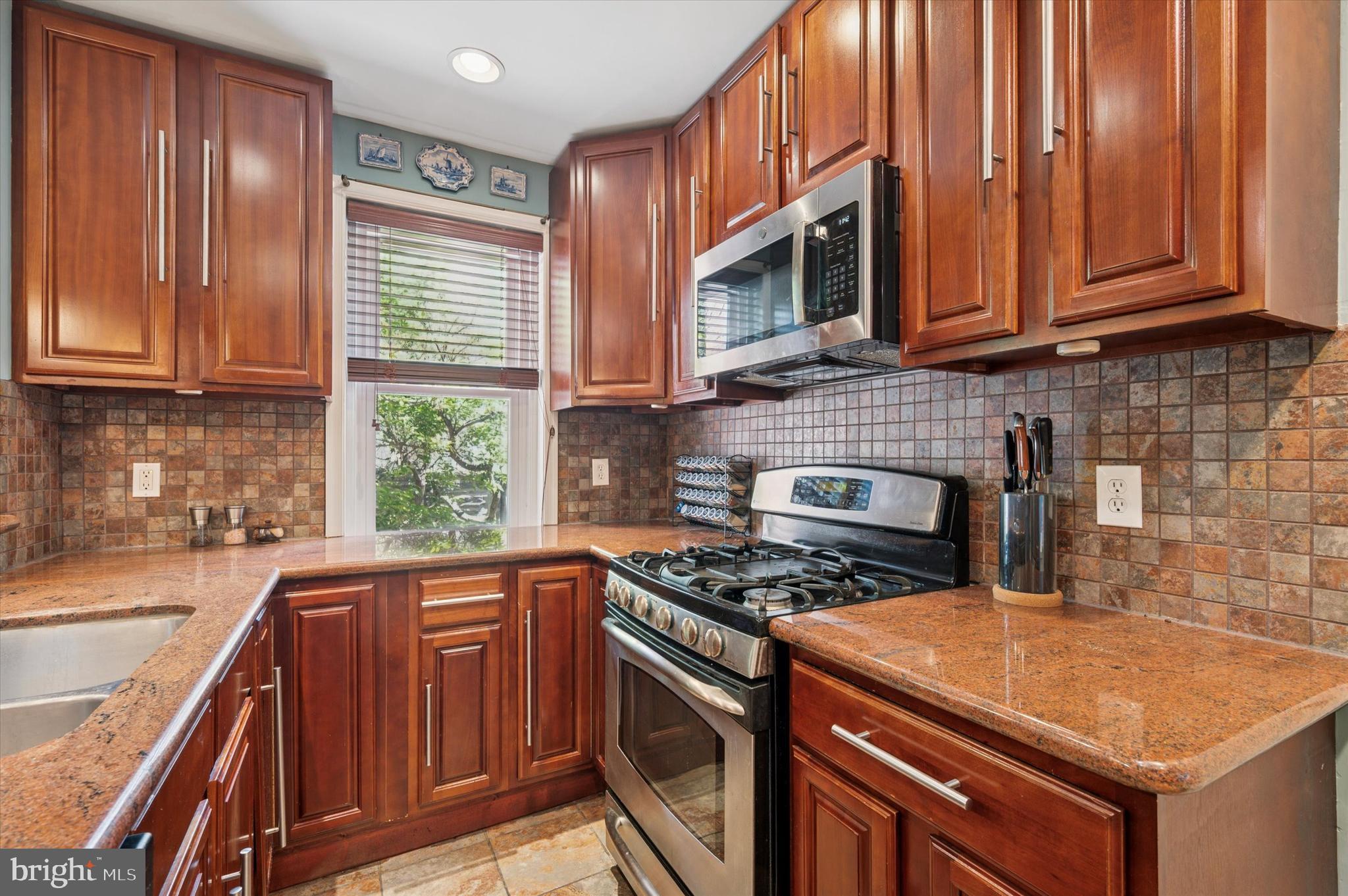 13 Chatham Road Ardmore, PA 19003 - Photo 17 of 35 a kitchen with stainless steel appliances granite countertop a stove a sink and a microwave