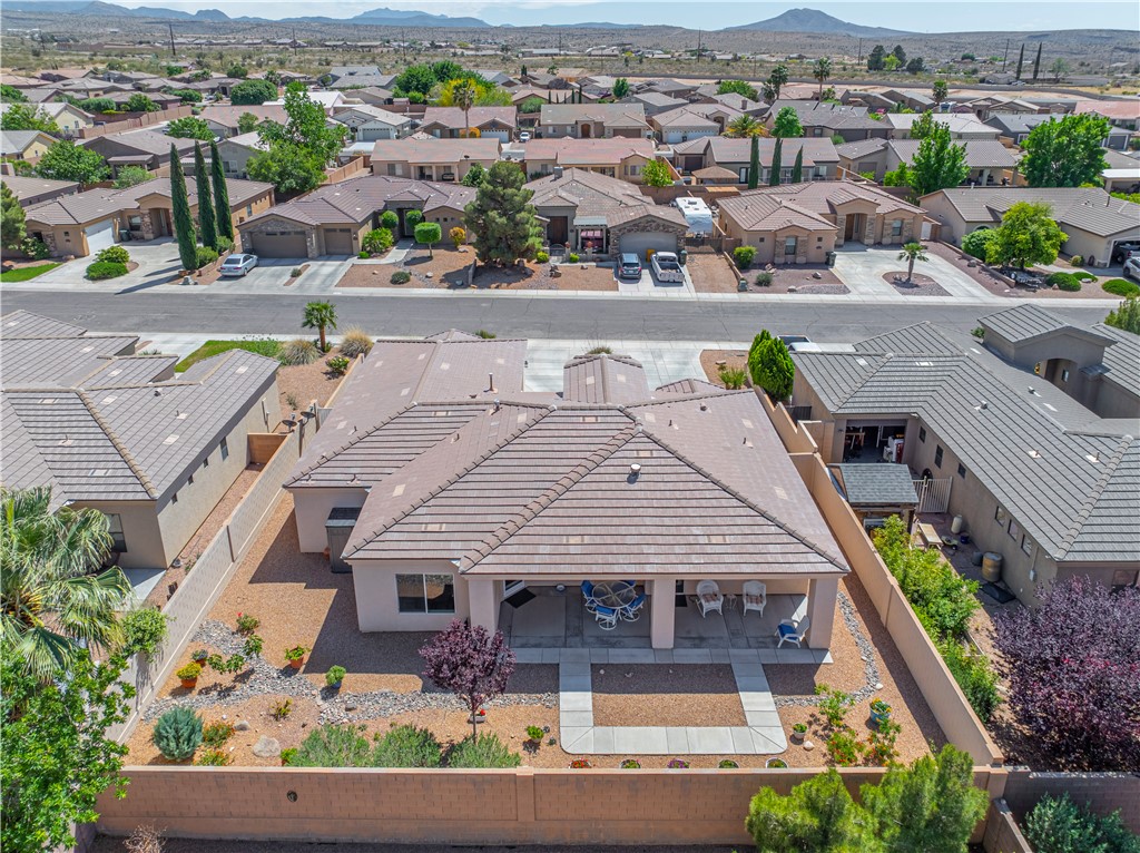3315 Rainbow Mine Road Kingman, AZ 86401 - Photo 41 of 54 The property features a private backyard with a covered patio, desert landscaping, and a surrounding privacy wall