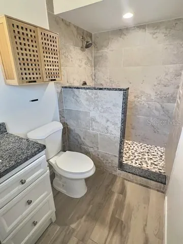 a bathroom with a toilet and a shower