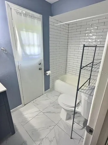 a bathroom with a toilet and a shower