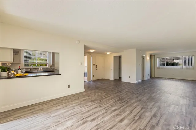 a view of a livingroom with wooden floor and windows