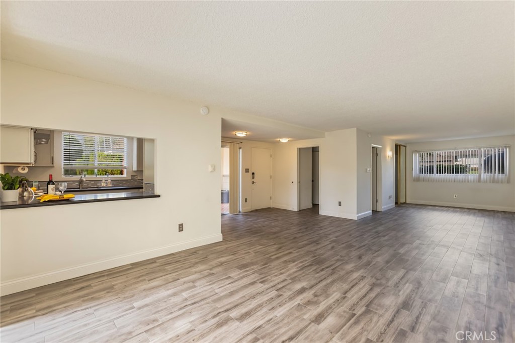 23033 Maple Avenue, Unit A Torrance, CA 90505 - Photo 12 of 45 a view of a livingroom with wooden floor and windows