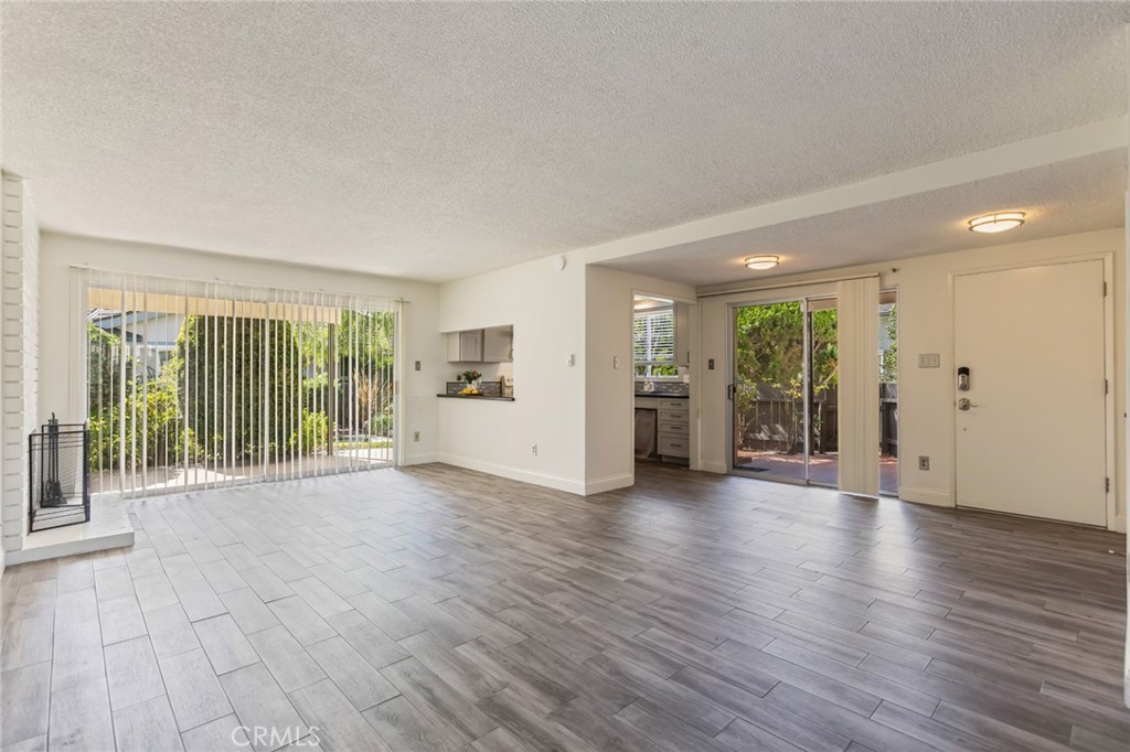 23033 Maple Avenue, Unit A Torrance, CA 90505 - Photo 14 of 45 a view of an empty room with wooden floor and a window