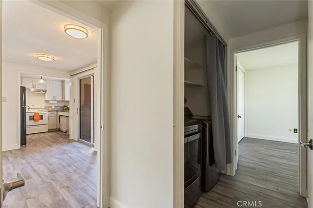 a view of a hallway and a livingroom with wooden floor