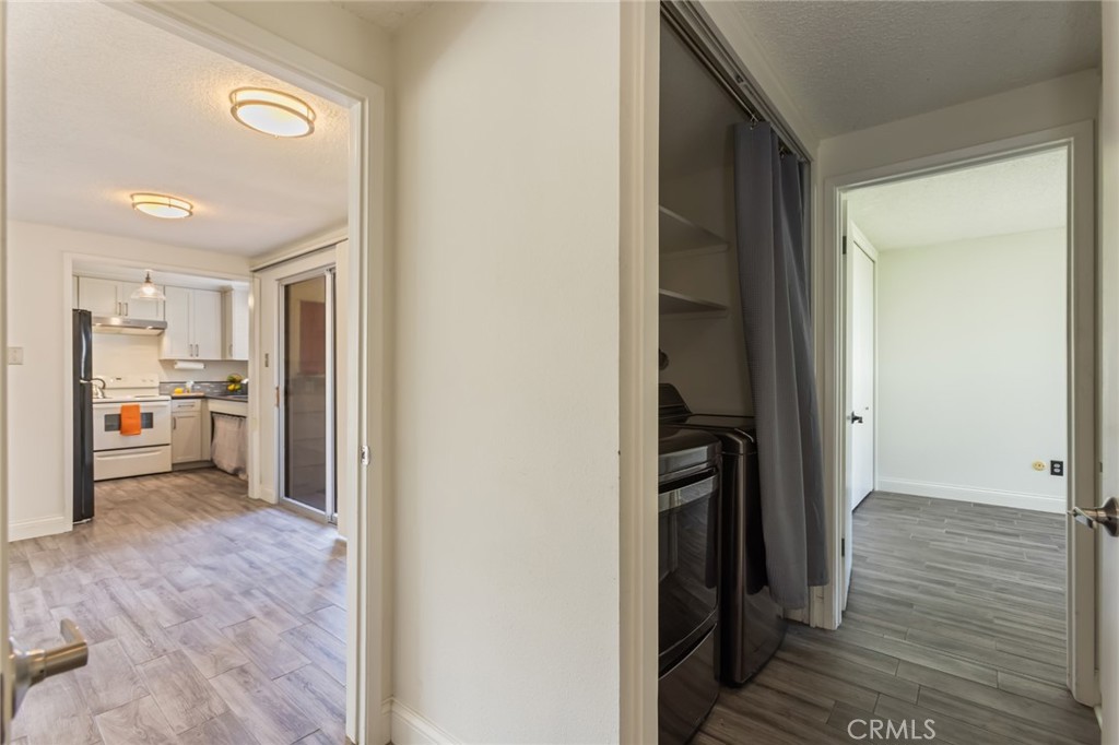 23033 Maple Avenue, Unit A Torrance, CA 90505 - Photo 27 of 45 a view of a hallway and a livingroom with wooden floor