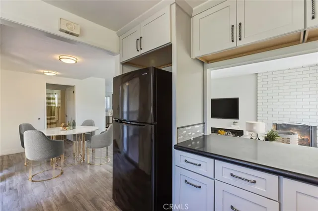 a kitchen with stainless steel appliances a refrigerator and a stove top oven