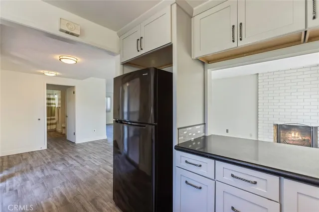 a kitchen with a refrigerator sink and cabinets