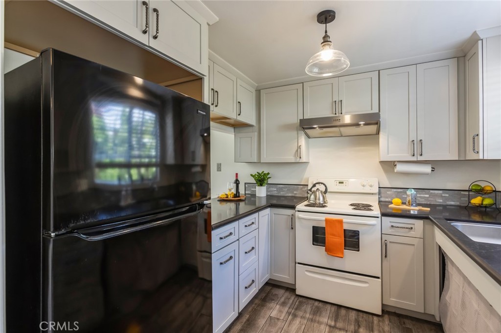 23033 Maple Avenue, Unit A Torrance, CA 90505 - Photo 7 of 45 a kitchen with a sink a stove and refrigerator
