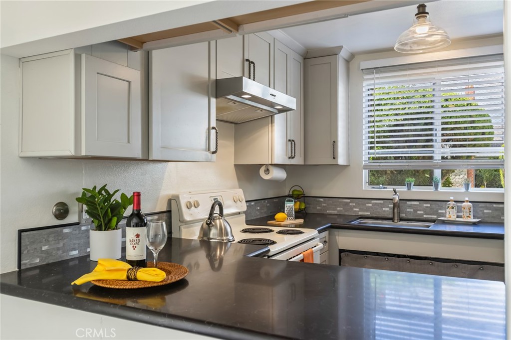 23033 Maple Avenue, Unit A Torrance, CA 90505 - Photo 10 of 45 a kitchen with a sink a stove and cabinets
