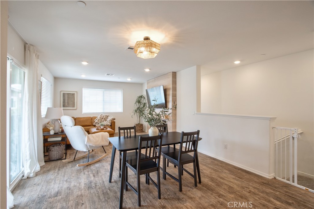 28397 Partridge Way, Unit 1001 Murrieta, CA 92563 - Photo 13 of 47 a view of a dining room with furniture and wooden floor