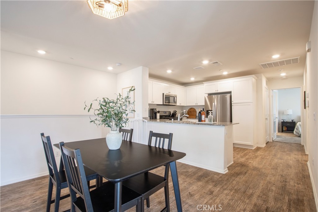 28397 Partridge Way, Unit 1001 Murrieta, CA 92563 - Photo 15 of 47 a kitchen with a table and chairs in it