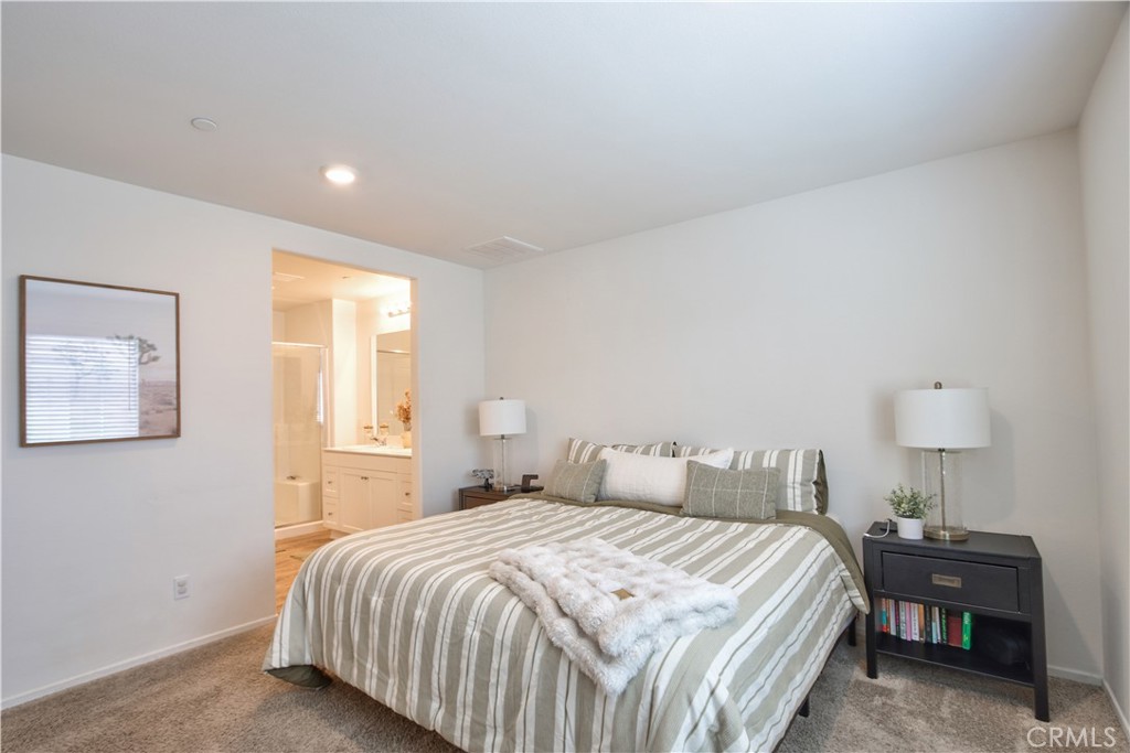 28397 Partridge Way, Unit 1001 Murrieta, CA 92563 - Photo 21 of 47 a bedroom with a bed and lamps