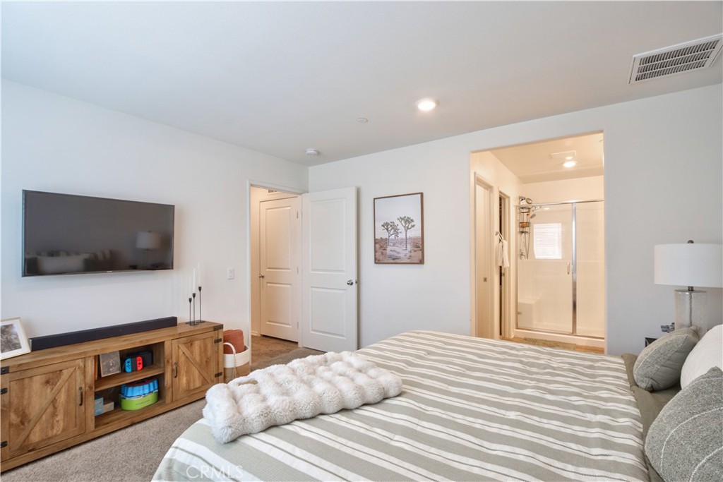 28397 Partridge Way, Unit 1001 Murrieta, CA 92563 - Photo 22 of 47 a bedroom with a bed and a flat screen tv