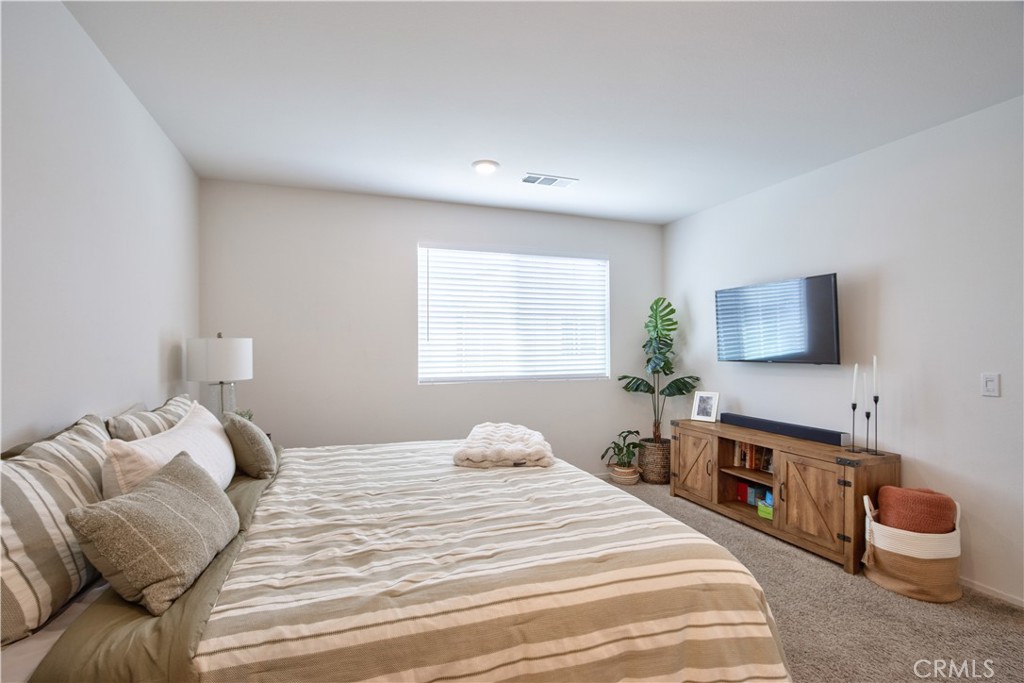 28397 Partridge Way, Unit 1001 Murrieta, CA 92563 - Photo 23 of 47 a bedroom with a bed and a flat screen tv