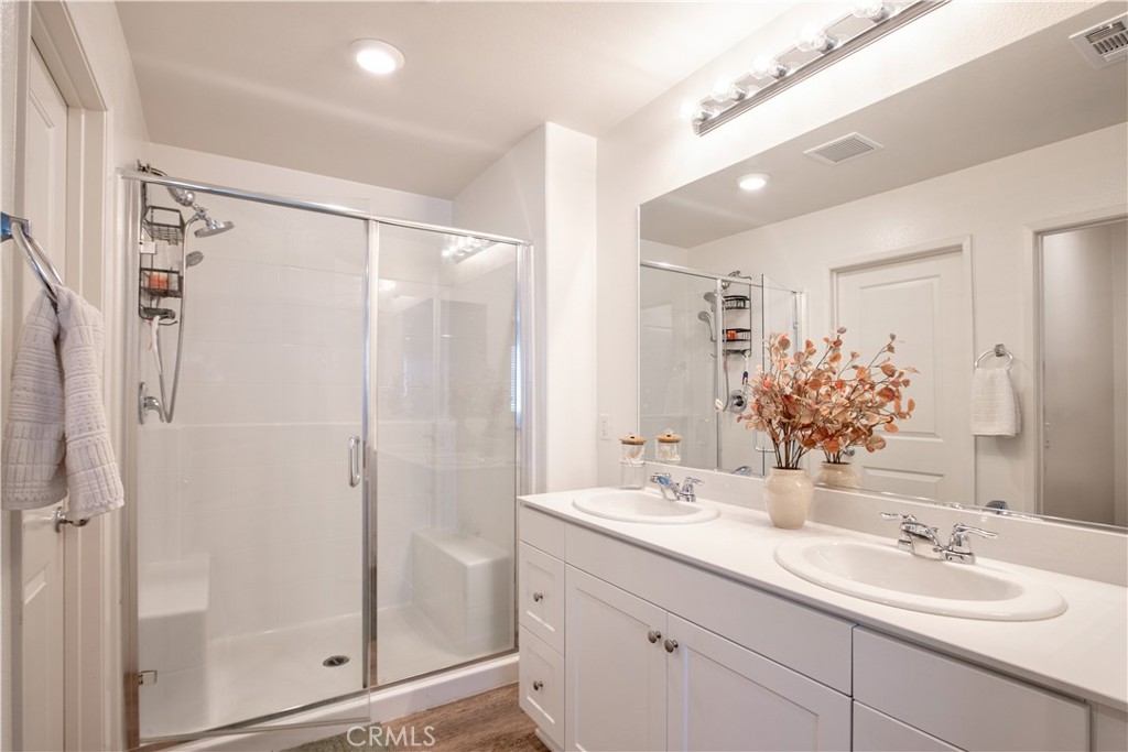 28397 Partridge Way, Unit 1001 Murrieta, CA 92563 - Photo 24 of 47 a bathroom with a shower sink vanity granite and mirror