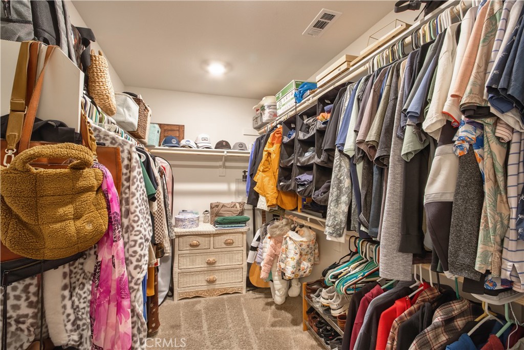 28397 Partridge Way, Unit 1001 Murrieta, CA 92563 - Photo 25 of 47 a view of walk in closet with clothes and shoes