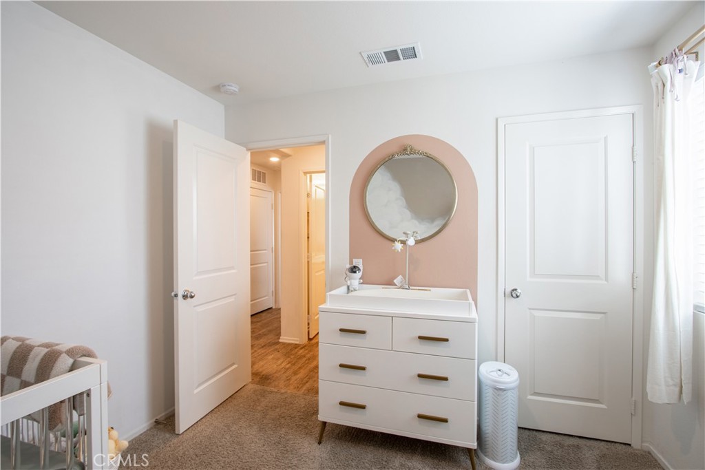 28397 Partridge Way, Unit 1001 Murrieta, CA 92563 - Photo 28 of 47 a bathroom with a sink a mirror and a shower