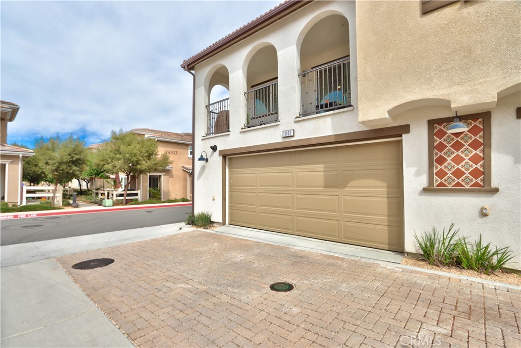 28397 Partridge Way, Unit 1001 Murrieta, CA 92563 - Photo 33 of 47 a front view of a house with a yard and garage