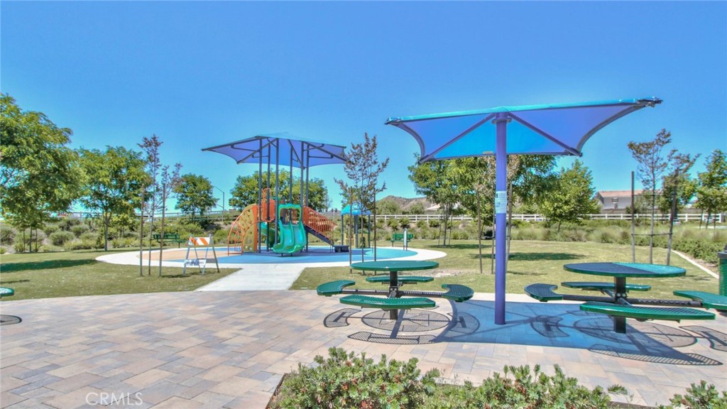 28397 Partridge Way, Unit 1001 Murrieta, CA 92563 - Photo 37 of 47 a view of a table and chairs under an umbrella