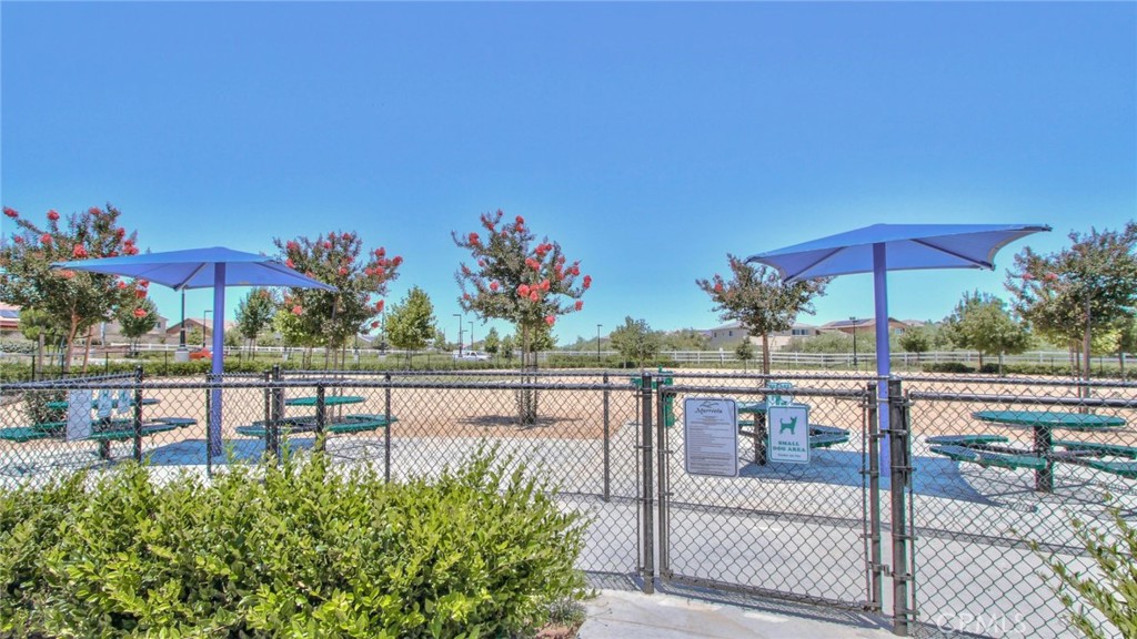 28397 Partridge Way, Unit 1001 Murrieta, CA 92563 - Photo 38 of 47 a view of a patio with chairs under an umbrella
