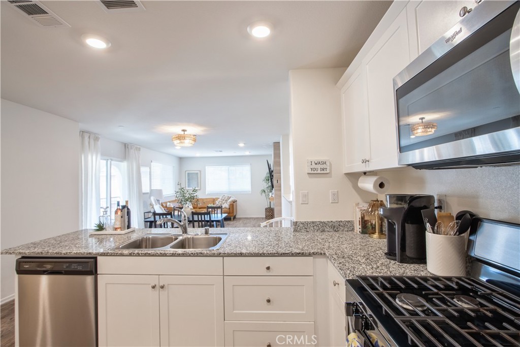 28397 Partridge Way, Unit 1001 Murrieta, CA 92563 - Photo 39 of 47 a kitchen with a sink and stove