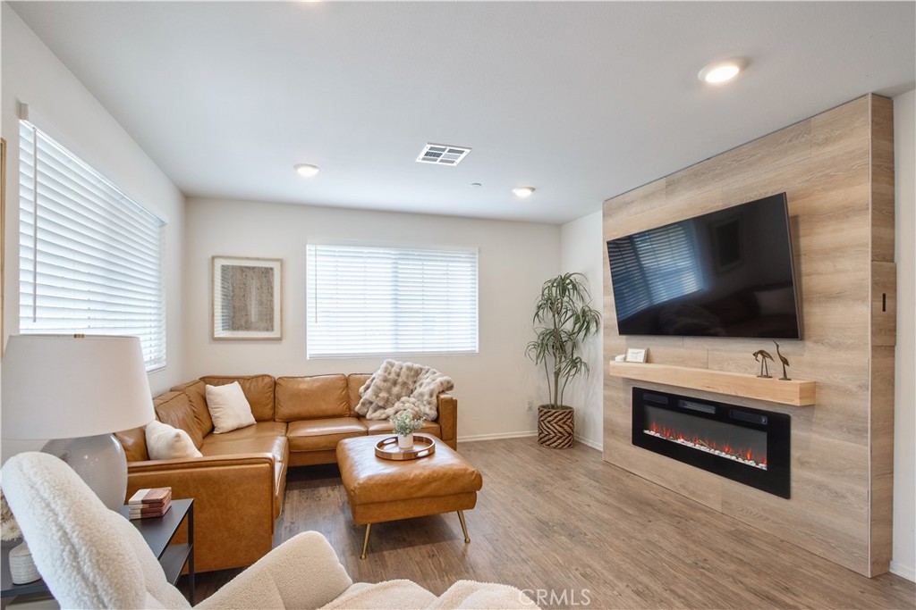 28397 Partridge Way, Unit 1001 Murrieta, CA 92563 - Photo 4 of 47 a living room with furniture and a flat screen tv