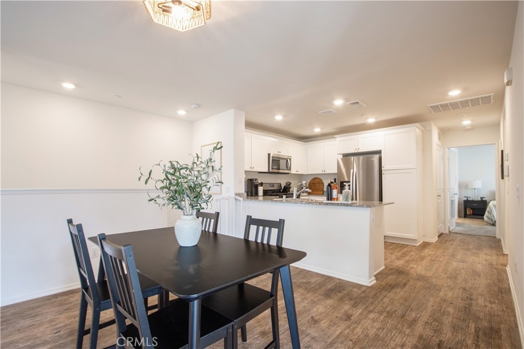 28397 Partridge Way, Unit 1001 Murrieta, CA 92563 - Photo 7 of 47 a kitchen with a table and chairs