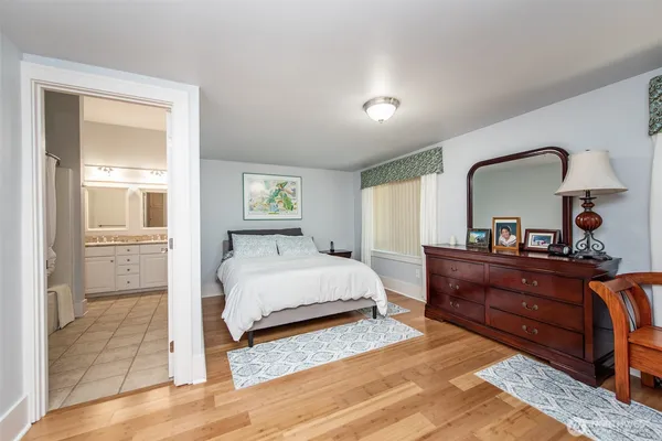 a bathroom with a granite countertop sink a toilet and shower
