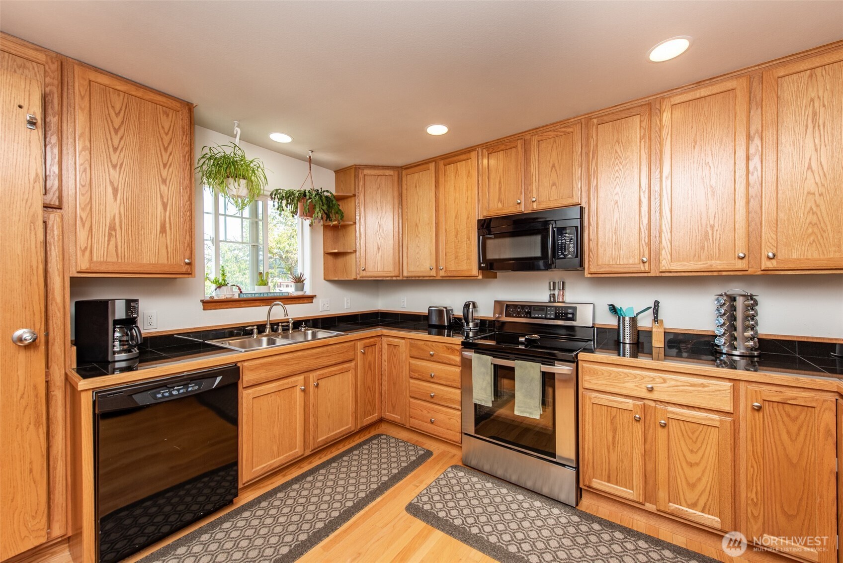 410 East Front Street Port Angeles, WA 98362 - Photo 15 of 32 a kitchen with stainless steel appliances granite countertop a stove a sink and a microwave