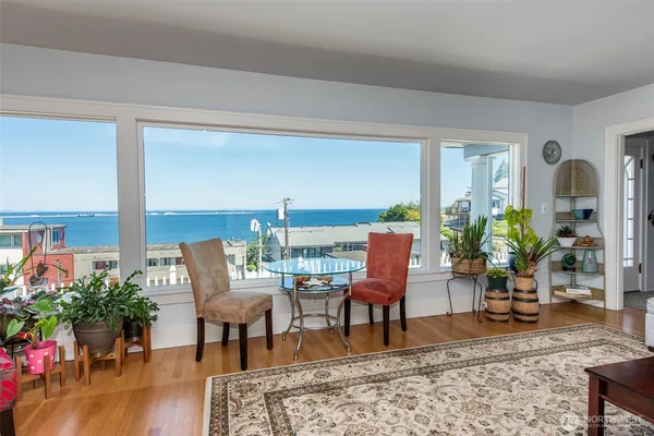 a living room with furniture potted plant and a table