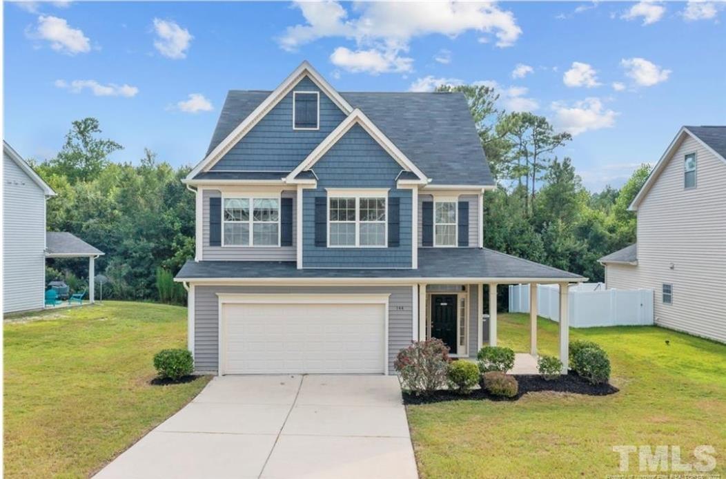 144 Bicentennial Way Cameron, NC 28326 - Photo 1 of 27 a front view of a house with garden