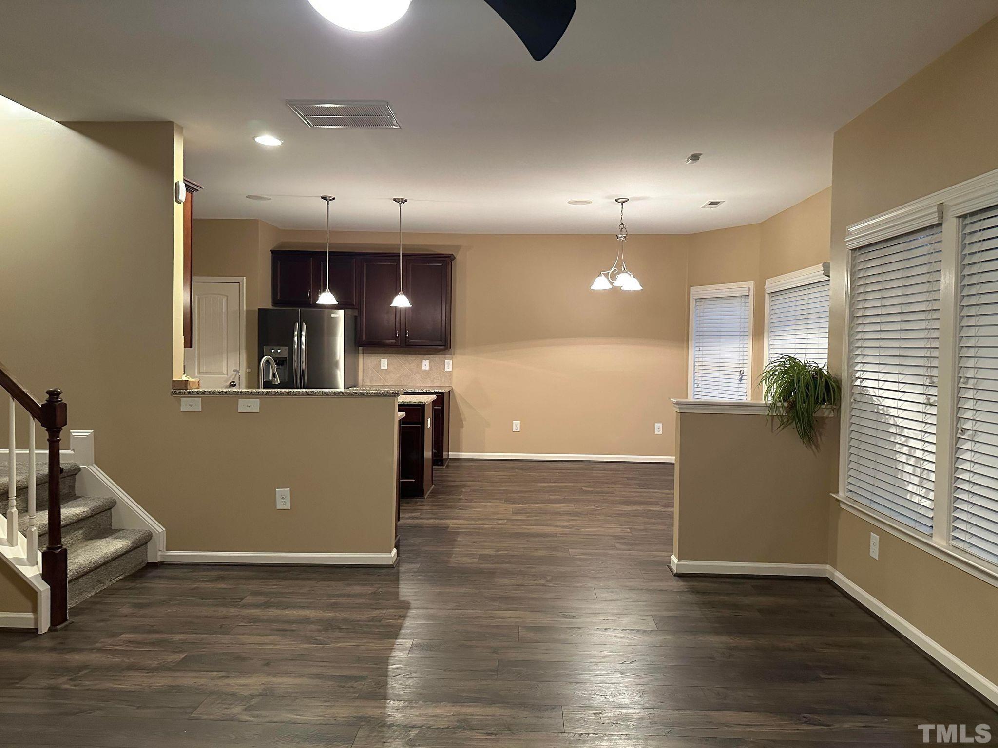 144 Bicentennial Way Cameron, NC 28326 - Photo 4 of 27 an open kitchen with kitchen island and stainless steel appliances