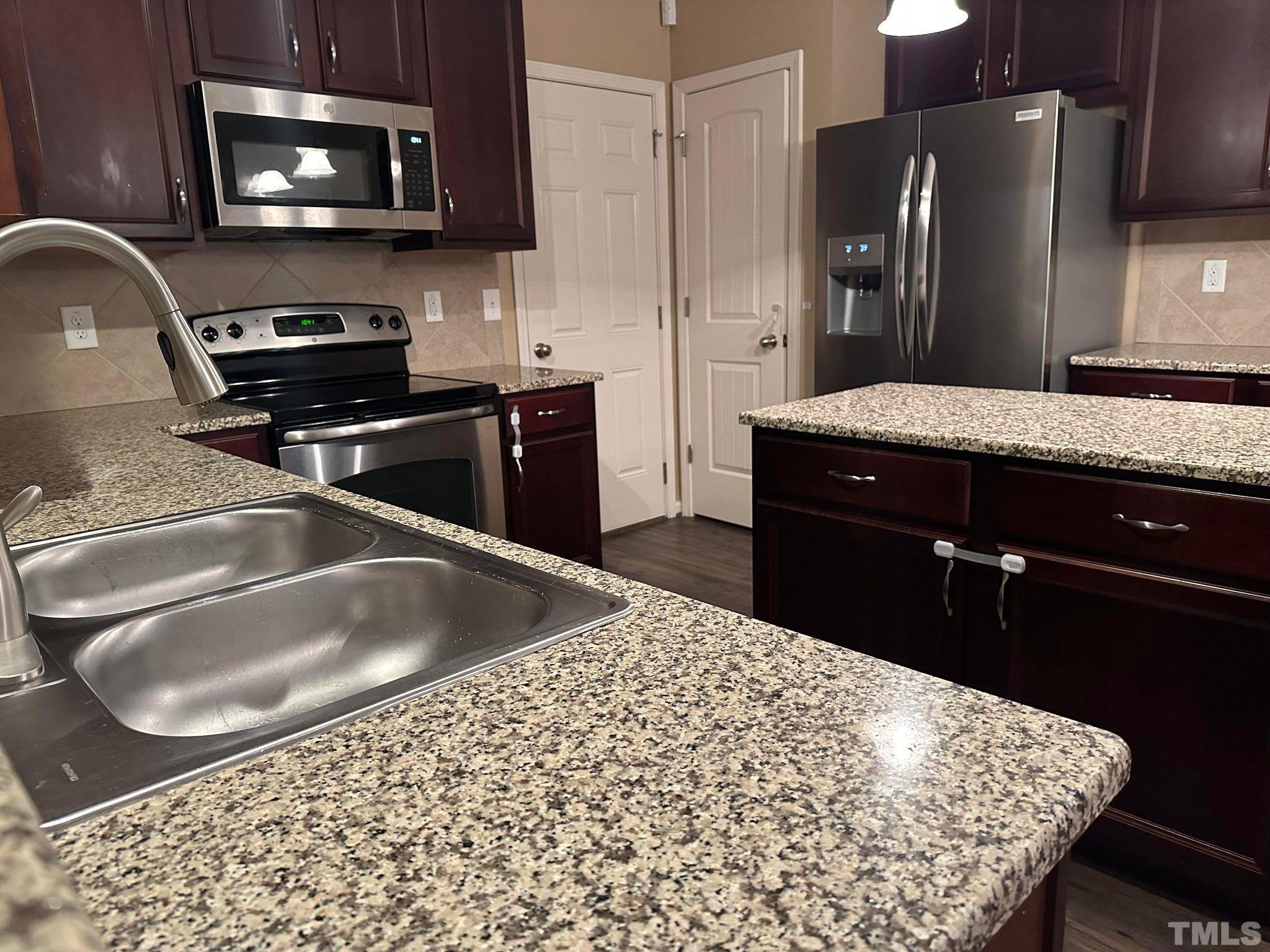 144 Bicentennial Way Cameron, NC 28326 - Photo 7 of 27 a kitchen with a sink appliances and cabinets