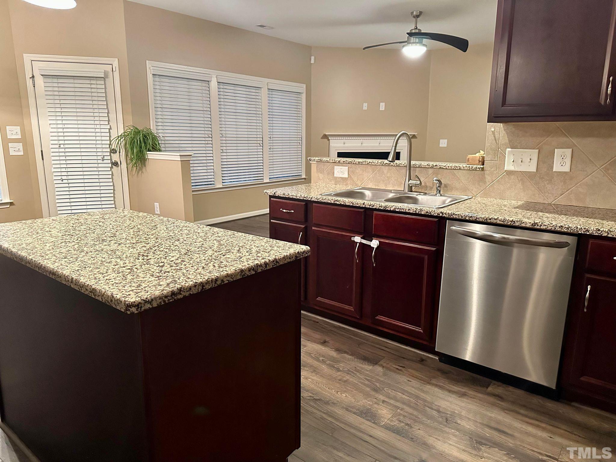 144 Bicentennial Way Cameron, NC 28326 - Photo 8 of 27 a kitchen with granite countertop wooden cabinets and a sink