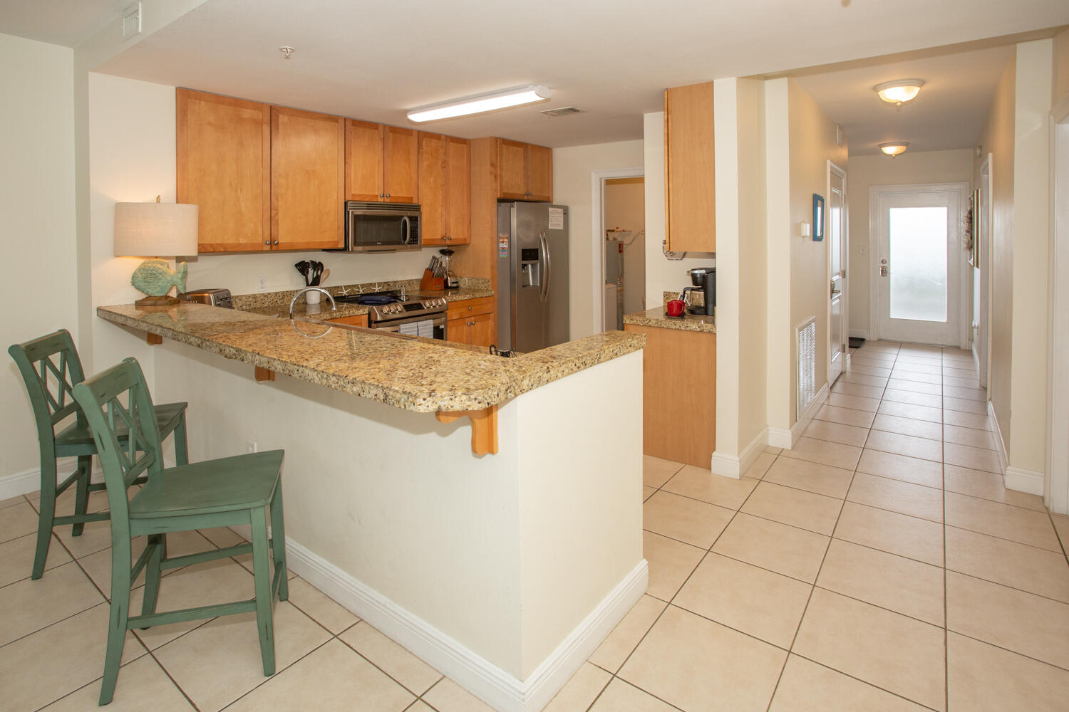 43 Cassine Way, Unit 402 Santa Rosa Beach, FL 32459 - Photo 20 of 52 a kitchen with stainless steel appliances granite countertop a refrigerator and a stove top oven
