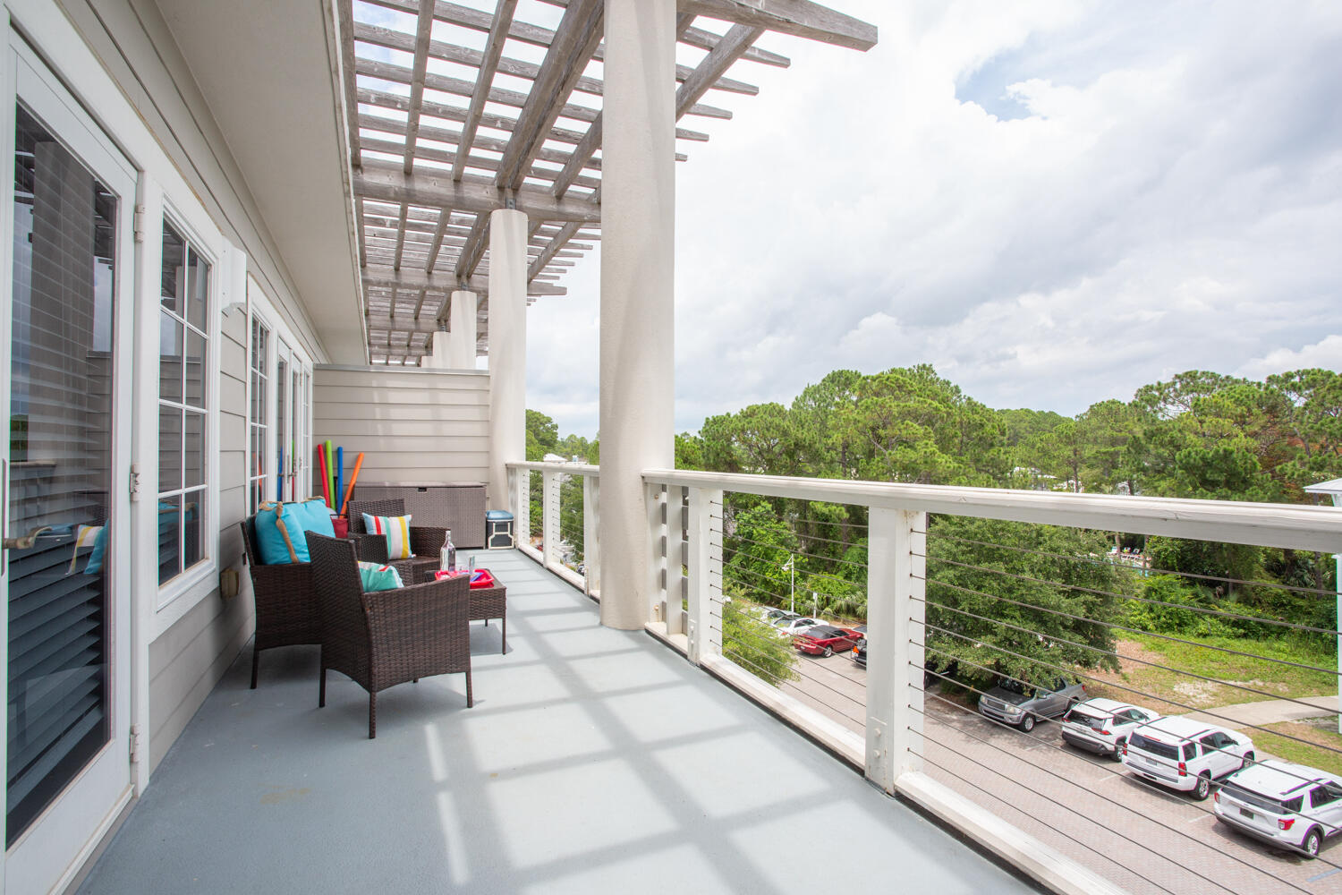 43 Cassine Way, Unit 402 Santa Rosa Beach, FL 32459 - Photo 36 of 52 a balcony with furniture and wooden floor