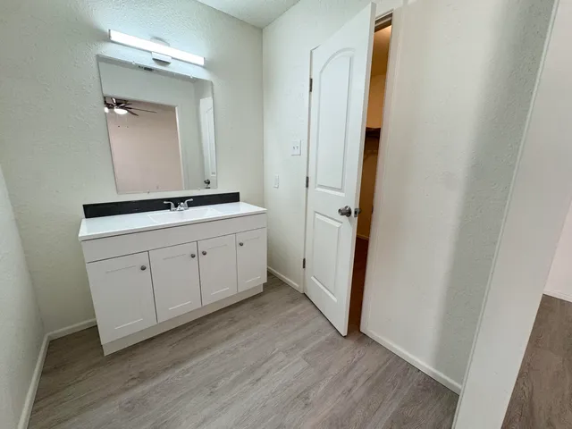 a hallway with sink and mirror