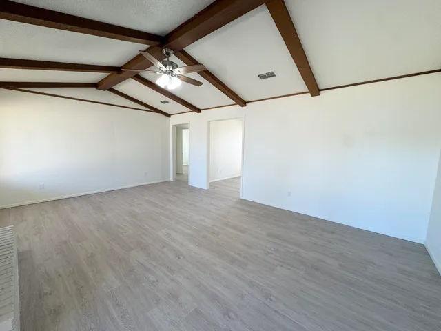 a view of a room with wooden floor