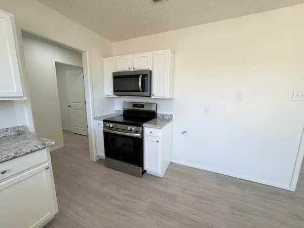 a kitchen with a stove and a microwave