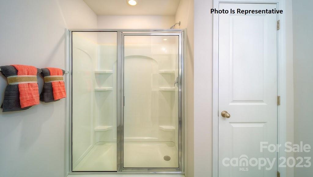 2116 Vanderlyn Street Monroe, NC 28112 - Photo 14 of 14 a bathroom with a glass shower door