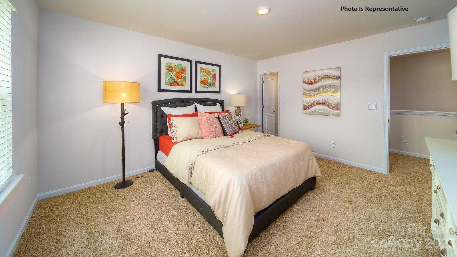 2116 Vanderlyn Street Monroe, NC 28112 - Photo 7 of 14 a bedroom with a bed and painting on the wall