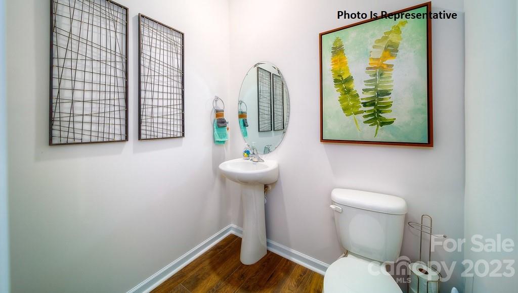 2116 Vanderlyn Street Monroe, NC 28112 - Photo 9 of 14 a bathroom with a toilet a sink and mirror