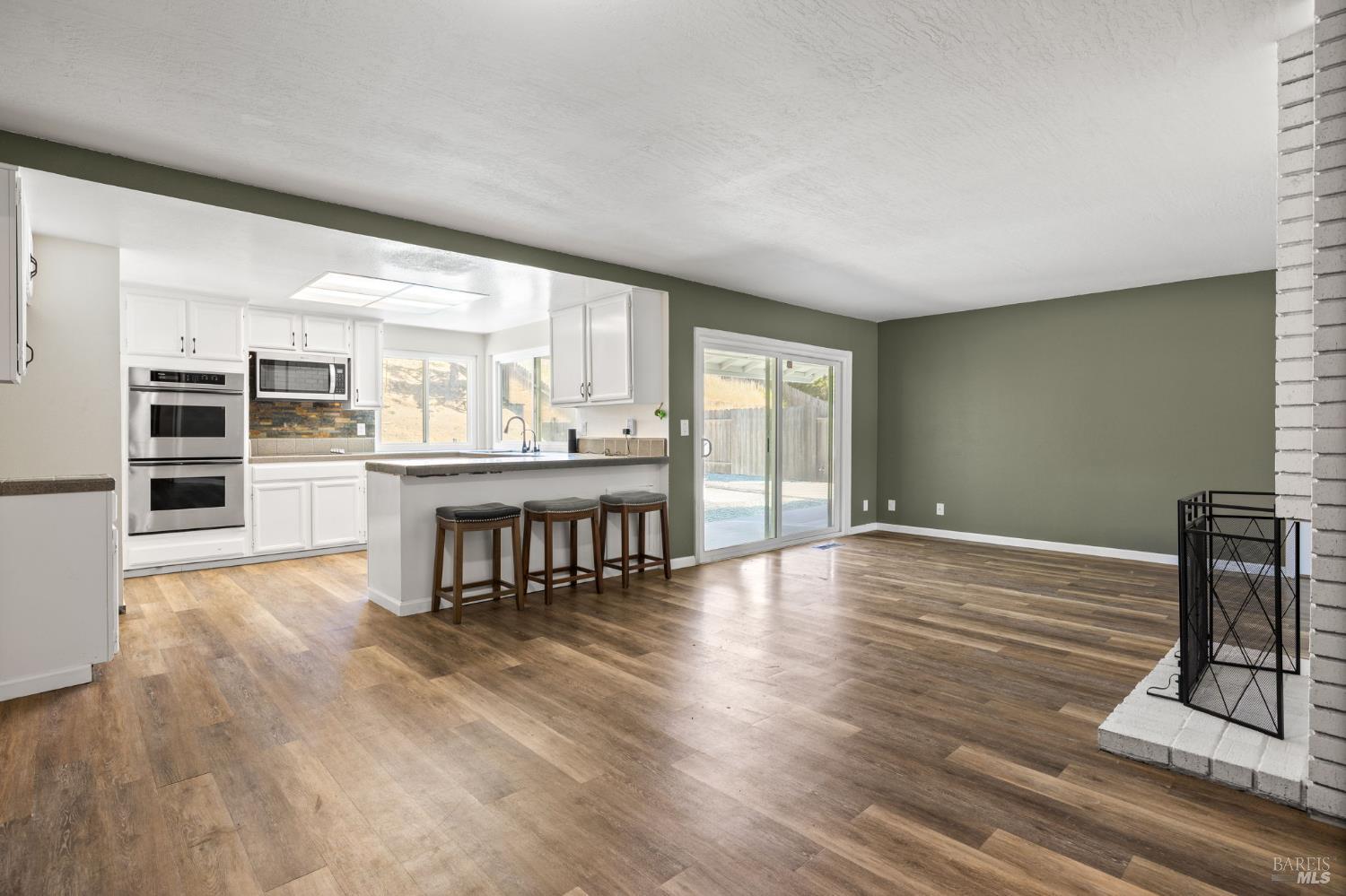 414 Brunswick Drive Vallejo, CA 94591 - Photo 64 of 73 a living room with hard wood floors and a kitchen