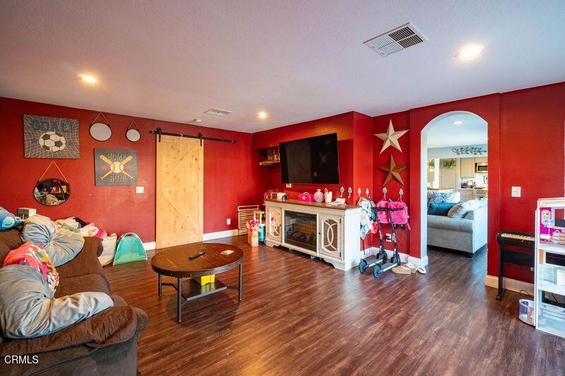 911 Indigo Place Oxnard, CA 93036 - Photo 11 of 30 a living room with furniture a flat screen tv and a fireplace