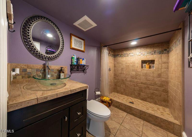 911 Indigo Place Oxnard, CA 93036 - Photo 13 of 30 a bathroom with a sink a toilet and shower