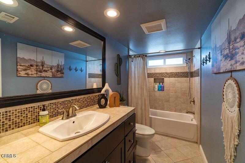 911 Indigo Place Oxnard, CA 93036 - Photo 23 of 30 a bathroom with a double vanity sink toilet and shower