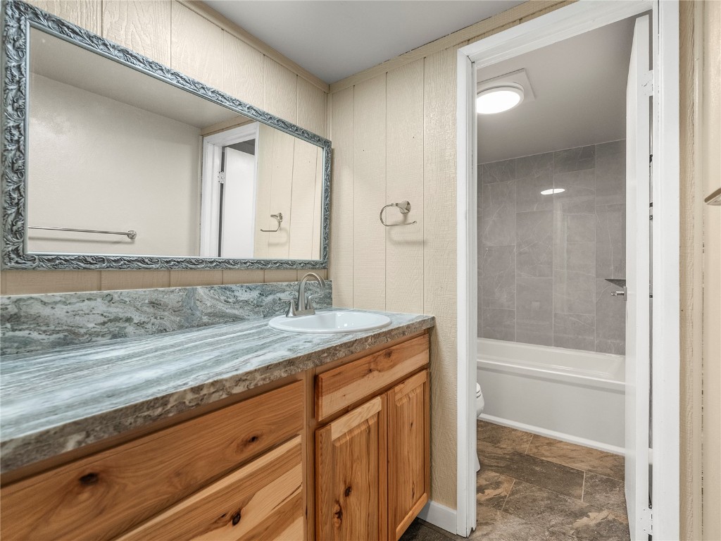 201 Bunker Hill Lode Road, Unit 6 Breckenridge, CO 80424 - Photo 18 of 20 a bathroom with a granite countertop sink a mirror and a bathtub