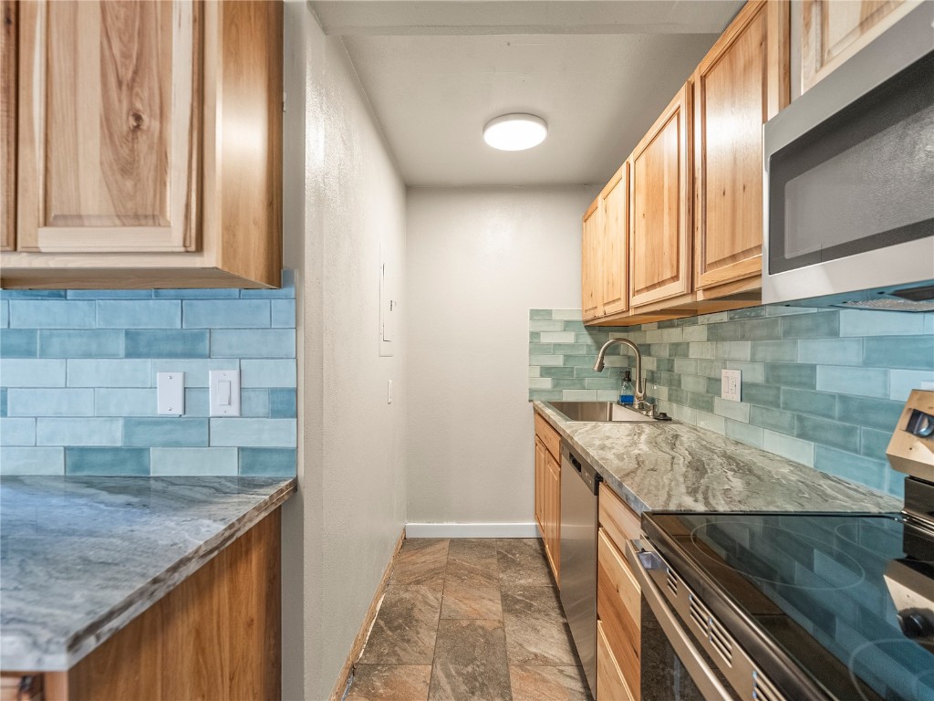 201 Bunker Hill Lode Road, Unit 6 Breckenridge, CO 80424 - Photo 7 of 20 a kitchen with granite countertop a sink and a stove